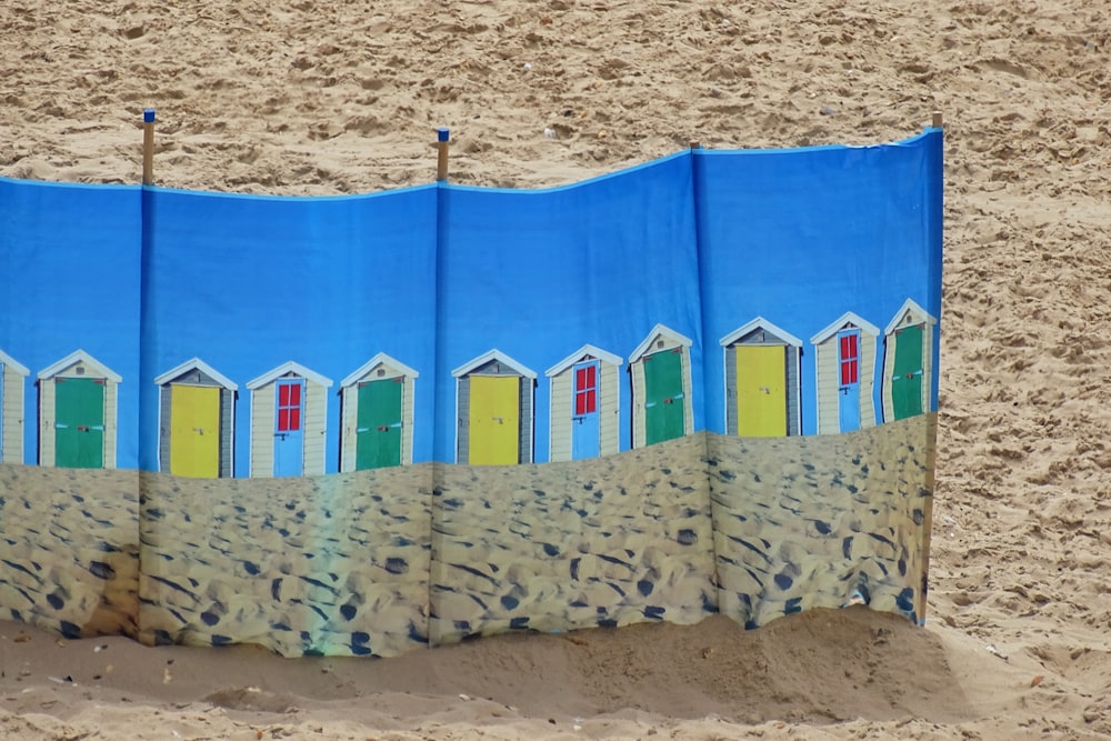 a beach towel with a picture of a row of beach huts