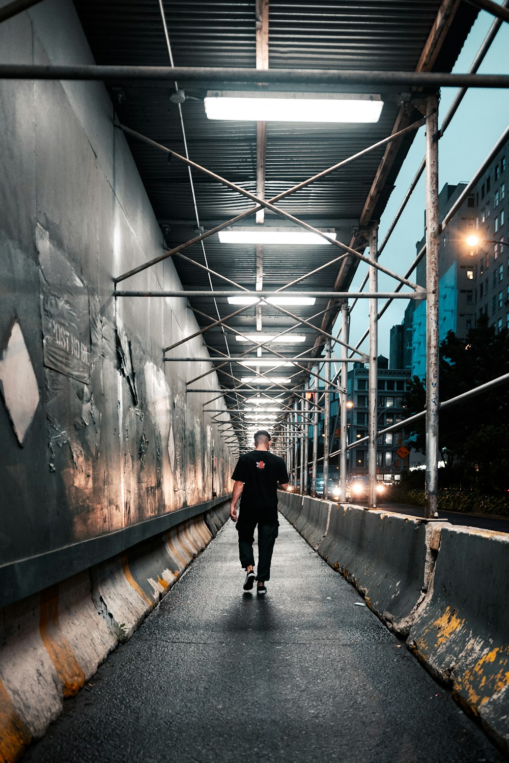 a person standing next to a train station