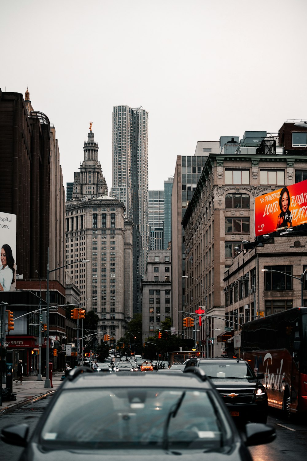 a city street filled with traffic and tall buildings