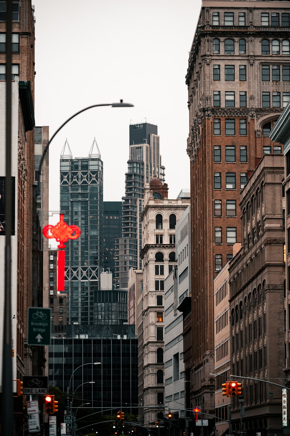 a city street filled with traffic surrounded by tall buildings