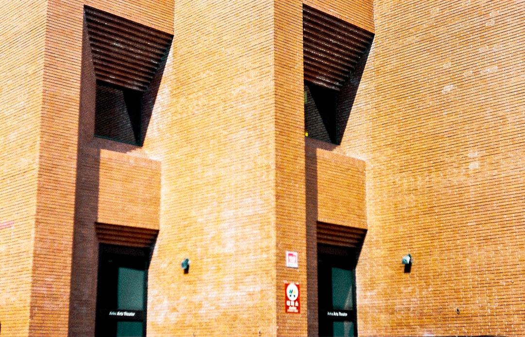 brown brick building with glass windows