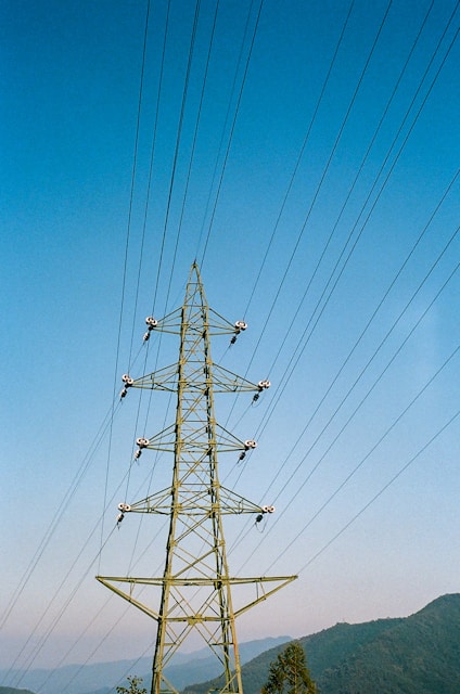 black electric post under blue sky during daytime