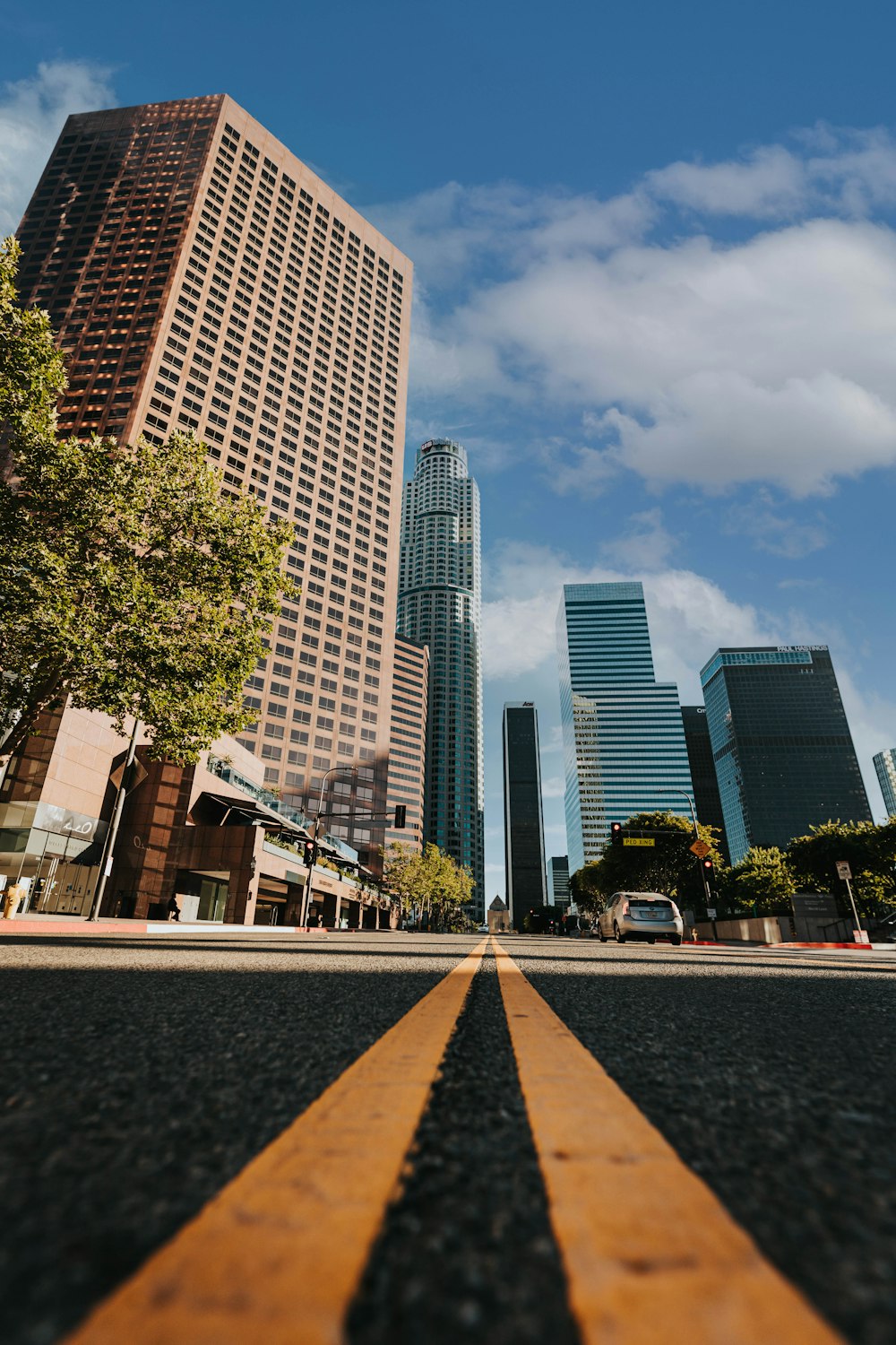 a city street with tall buildings in the background