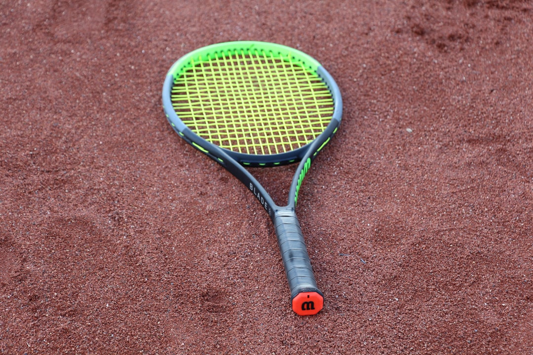 black and yellow tennis racket on brown carpet