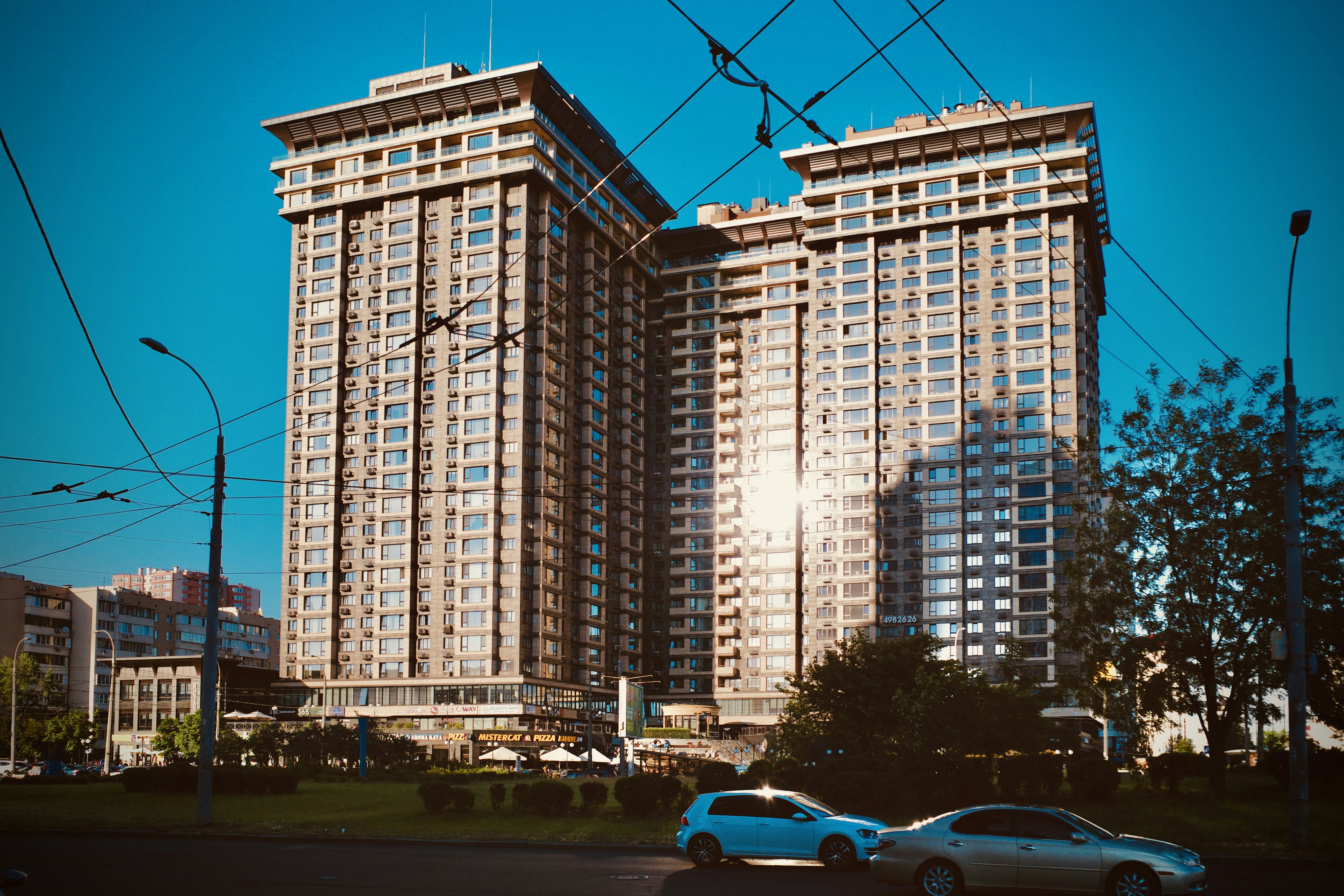 cars parked near high rise building during daytime
