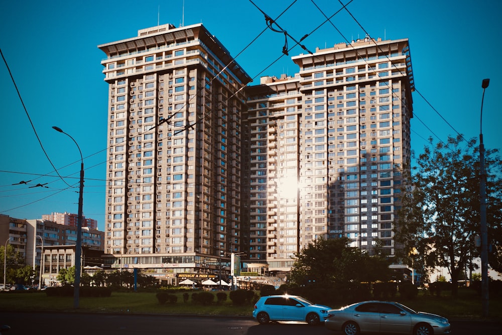 cars parked near high rise building during daytime