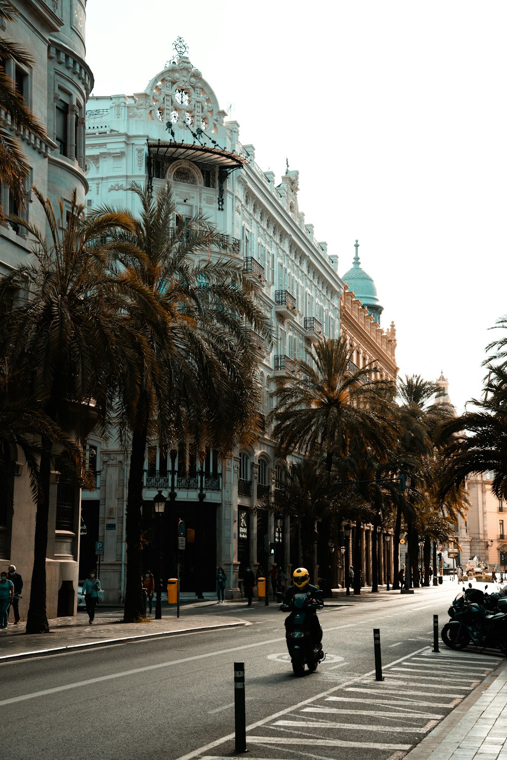 people walking on street near white concrete building during daytime