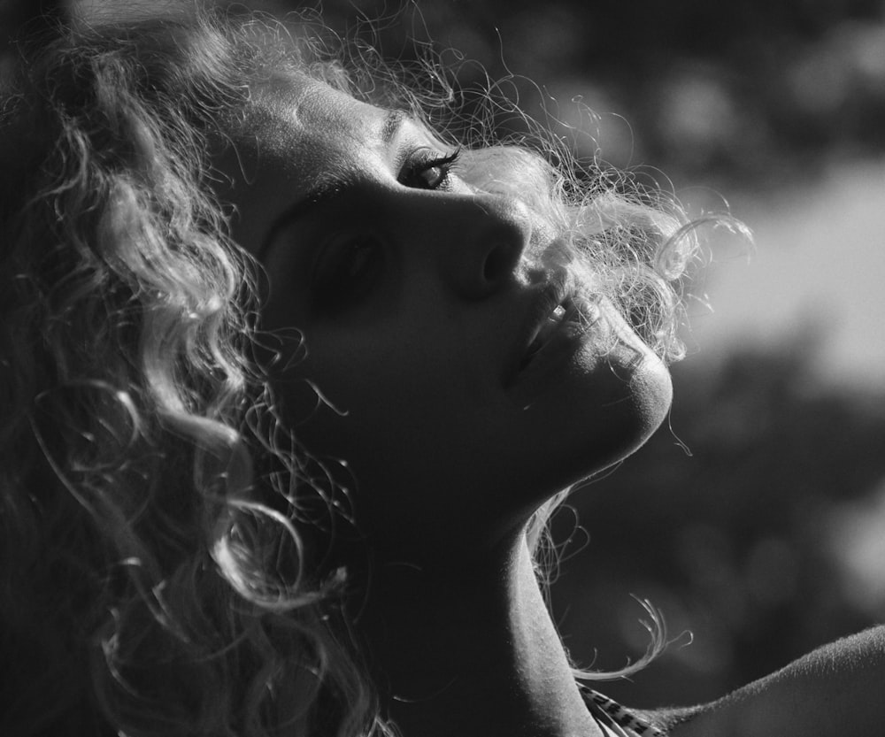 a black and white photo of a woman with curly hair