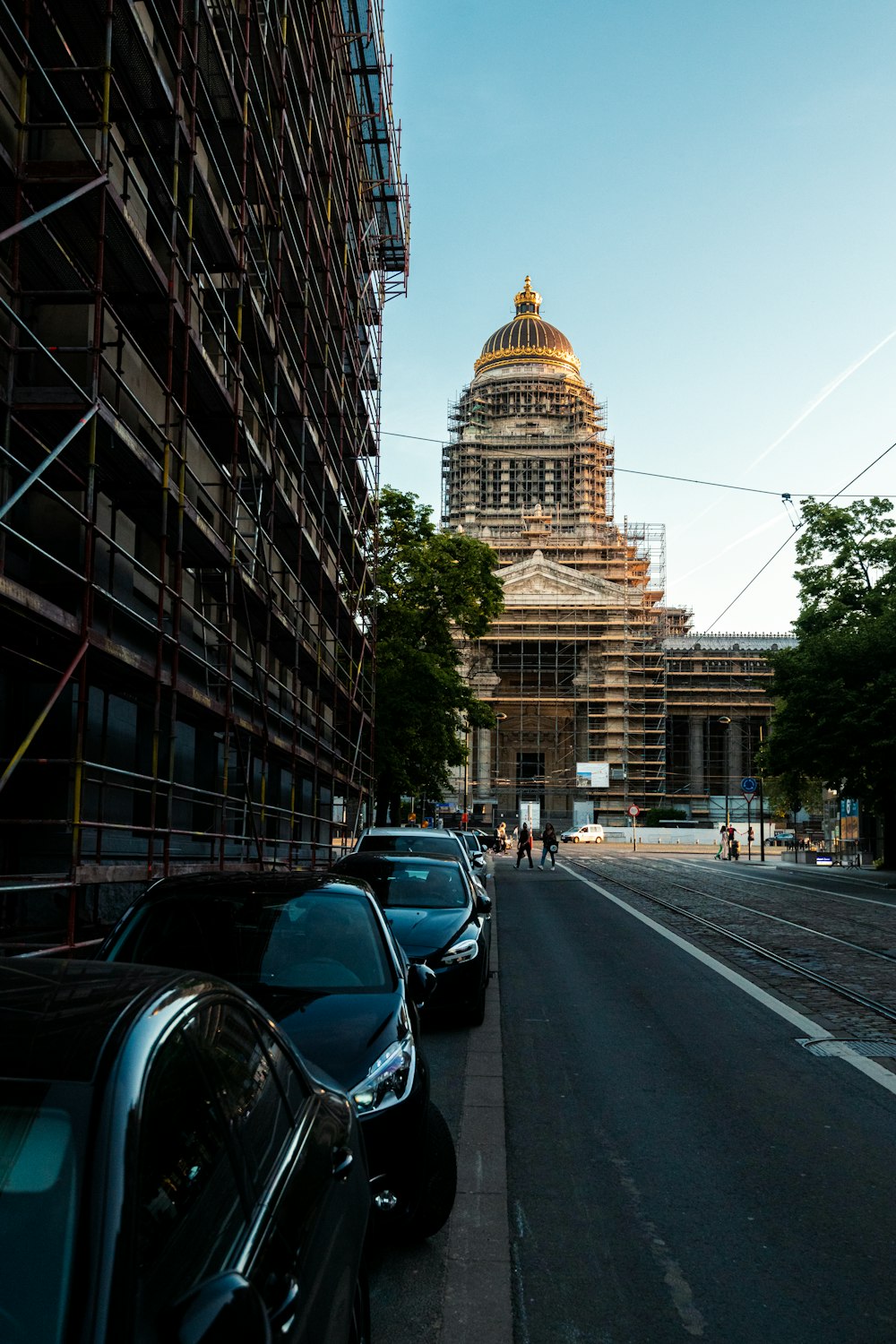 a row of cars parked on the side of a road