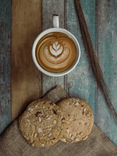 brown and white ceramic mug with cappuccino