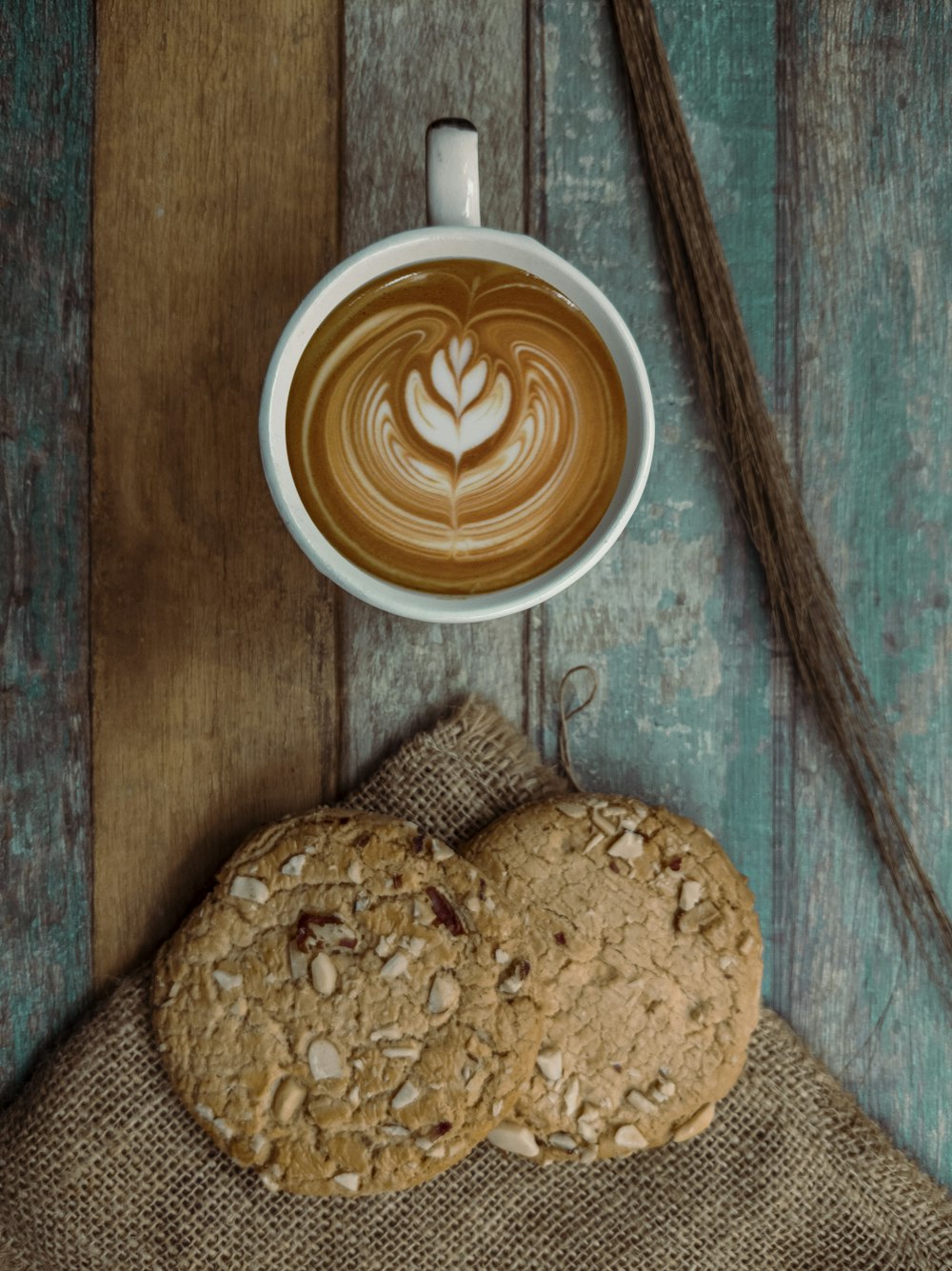 brown and white ceramic mug with cappuccino