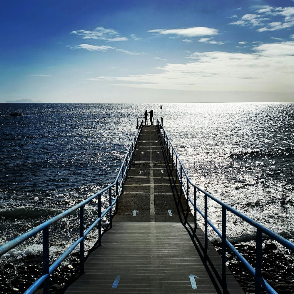 brown wooden dock on blue sea under blue sky during daytime