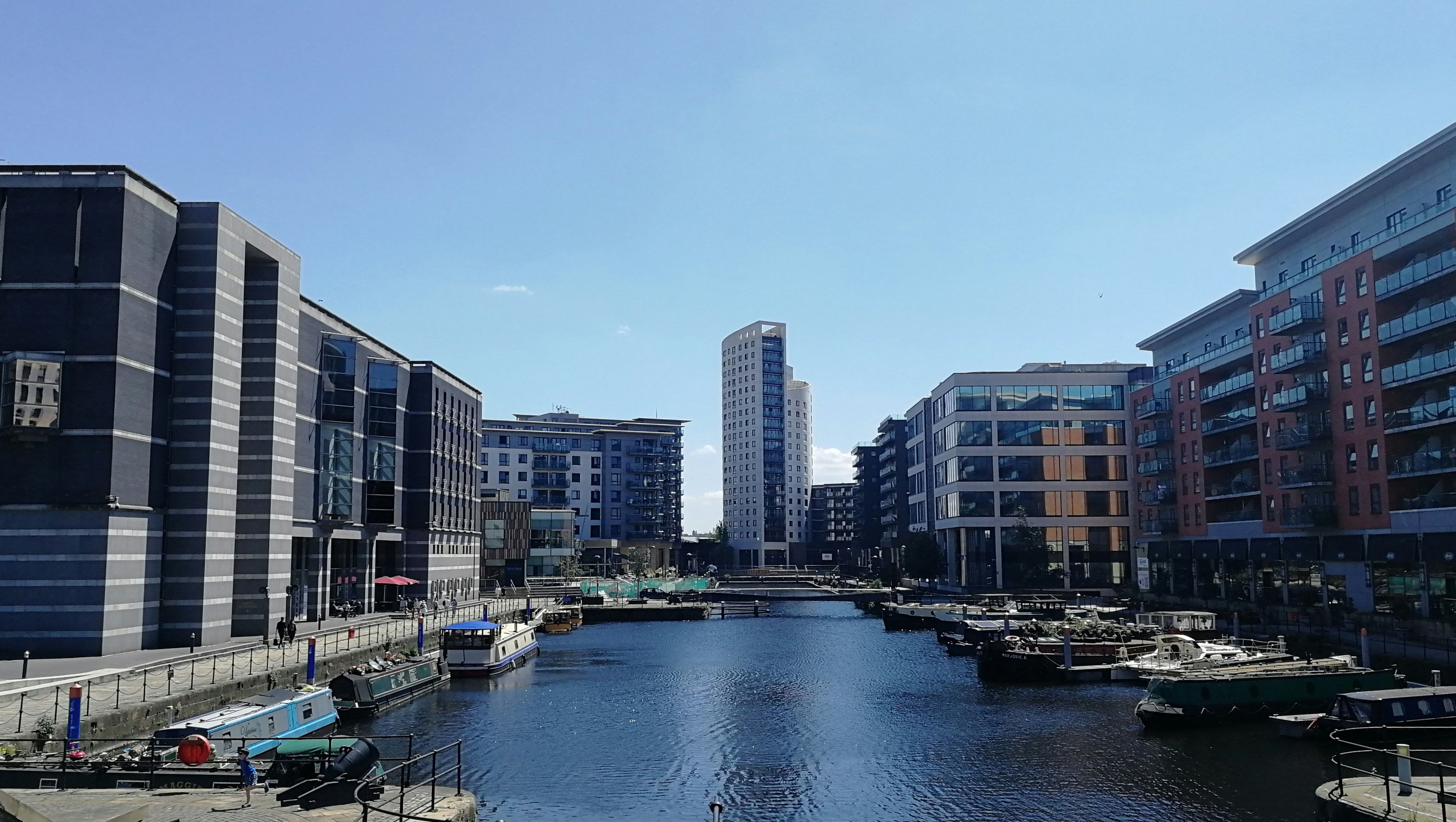 white and brown concrete building near body of water during daytime
