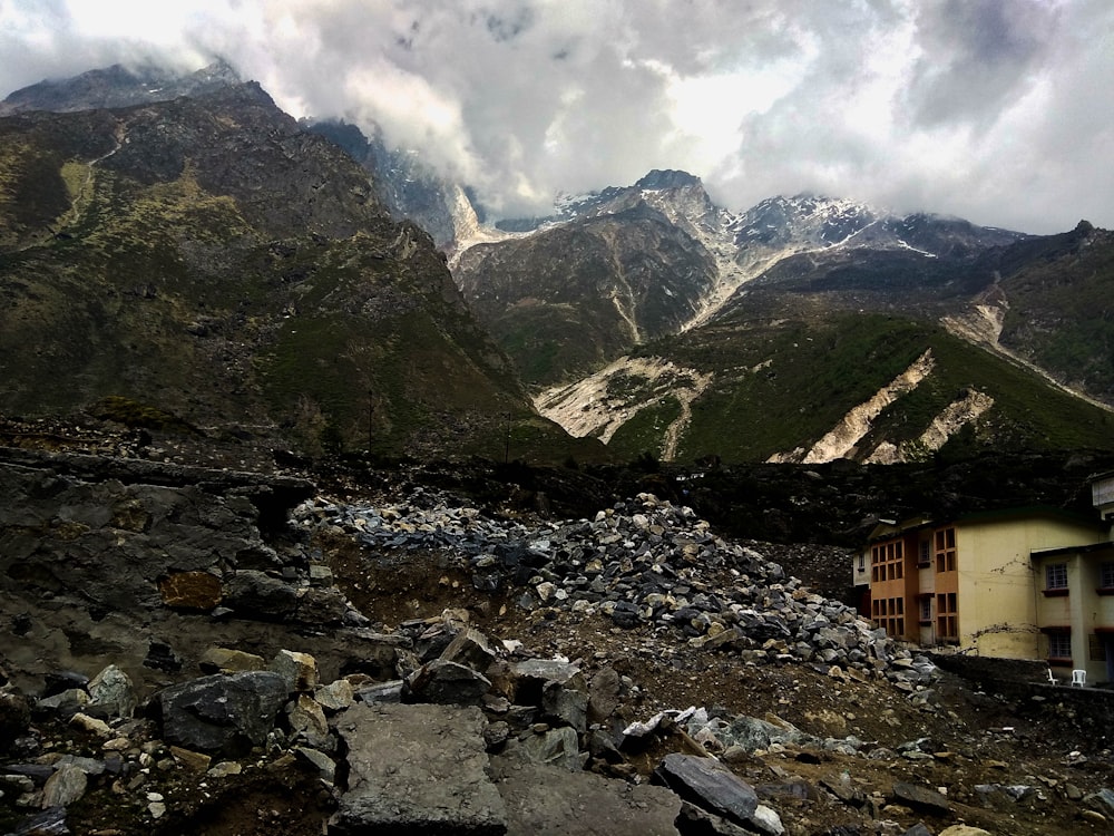 brown and green mountains under white clouds during daytime