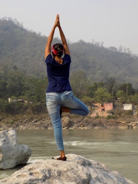A peaceful landscape with a person practicing yoga.