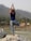 A serene landscape with a person practicing yoga outdoors.
