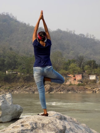 A serene outdoor scene with a person practicing yoga.