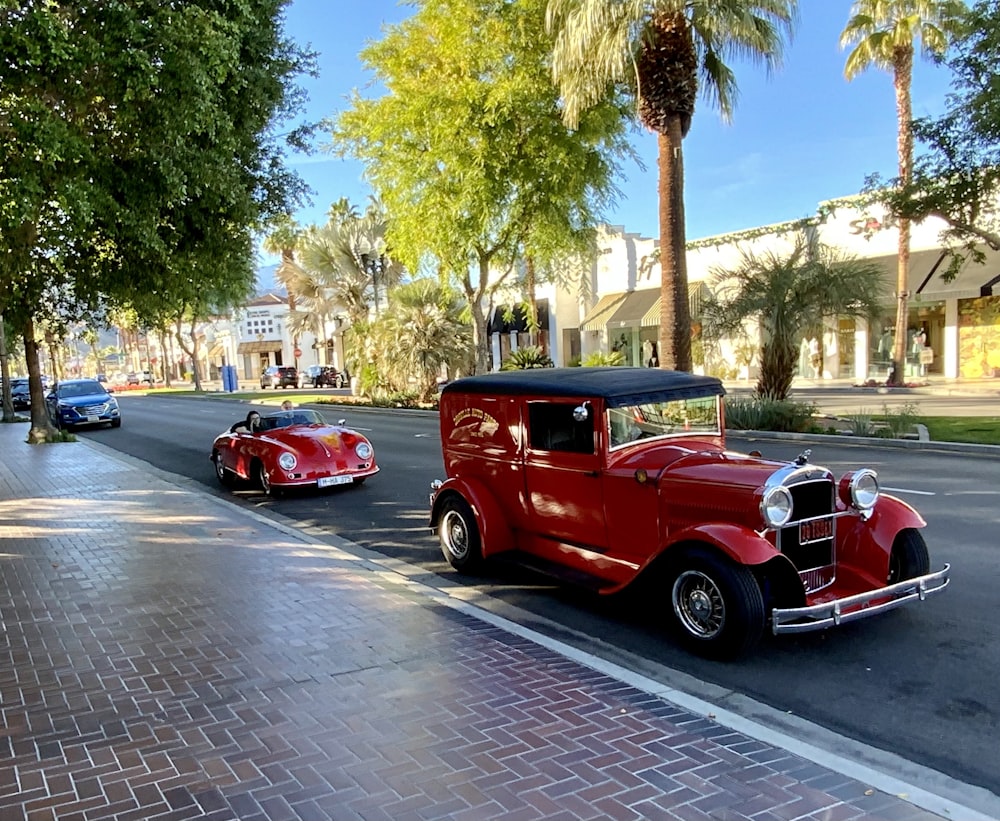 red vintage car on road during daytime
