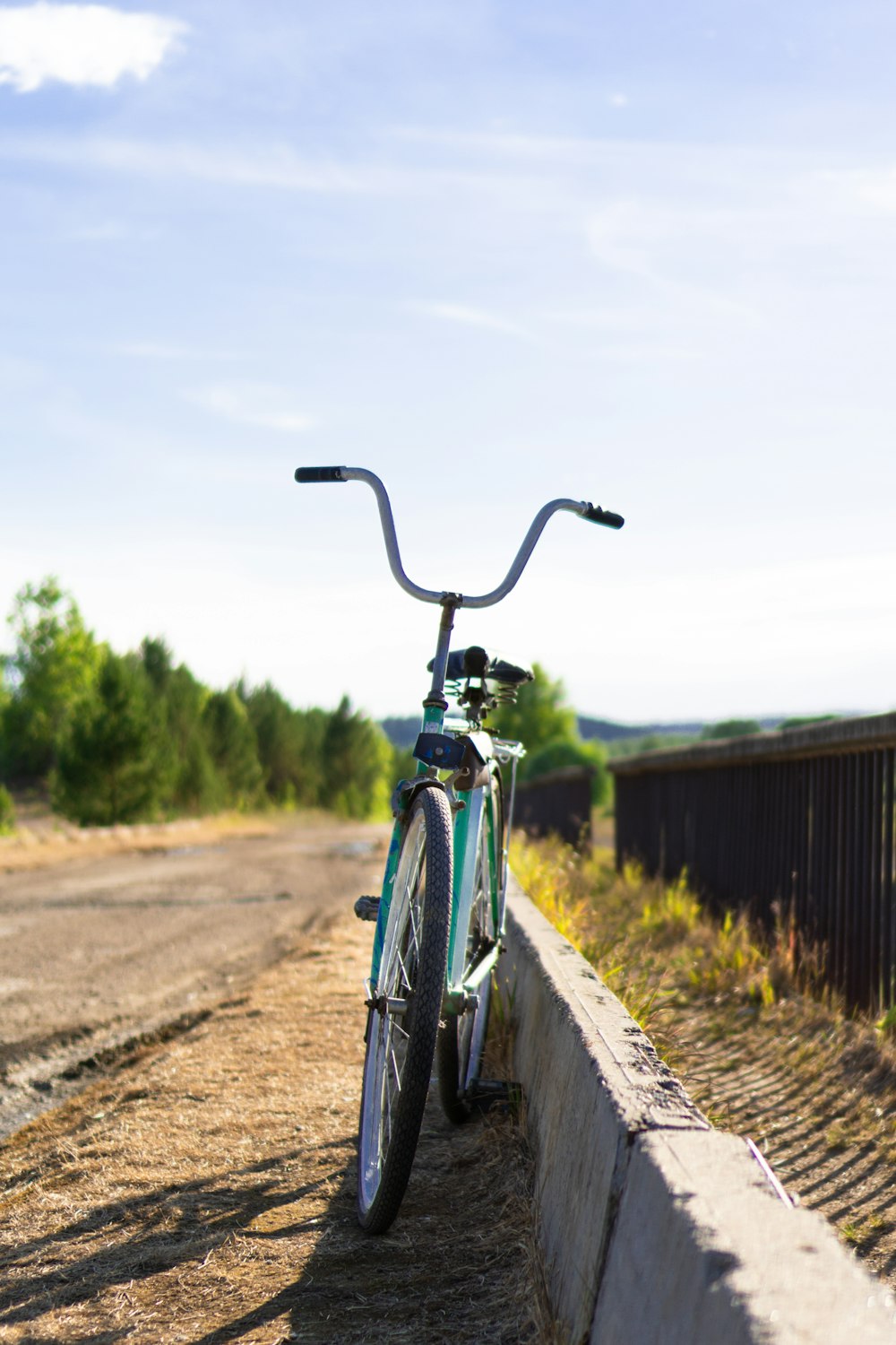 blue and black bicycle on road during daytime