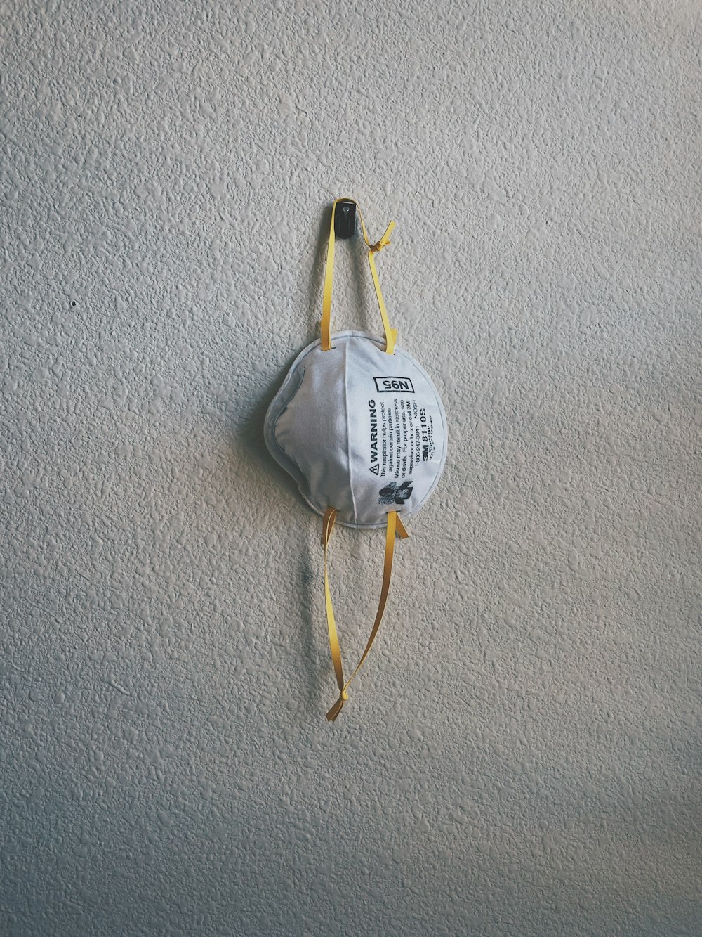 a face mask hanging on a wall