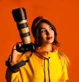 woman in yellow button up shirt holding black and silver microphone