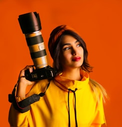 woman in yellow button up shirt holding black and silver microphone