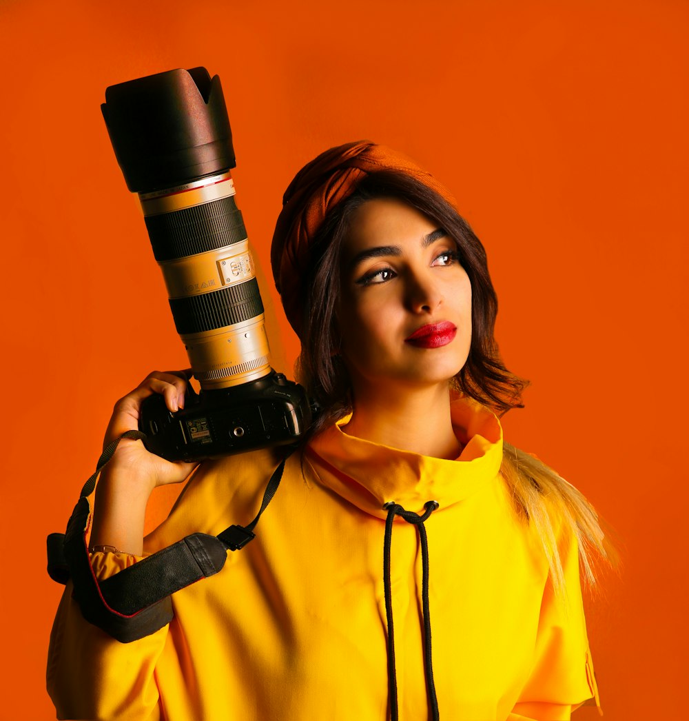 woman in yellow button up shirt holding black and silver microphone