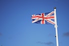 us a flag on pole under blue sky during daytime