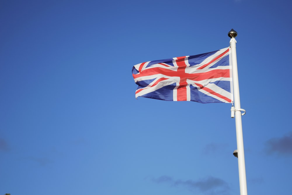 us a flag on pole under blue sky during daytime