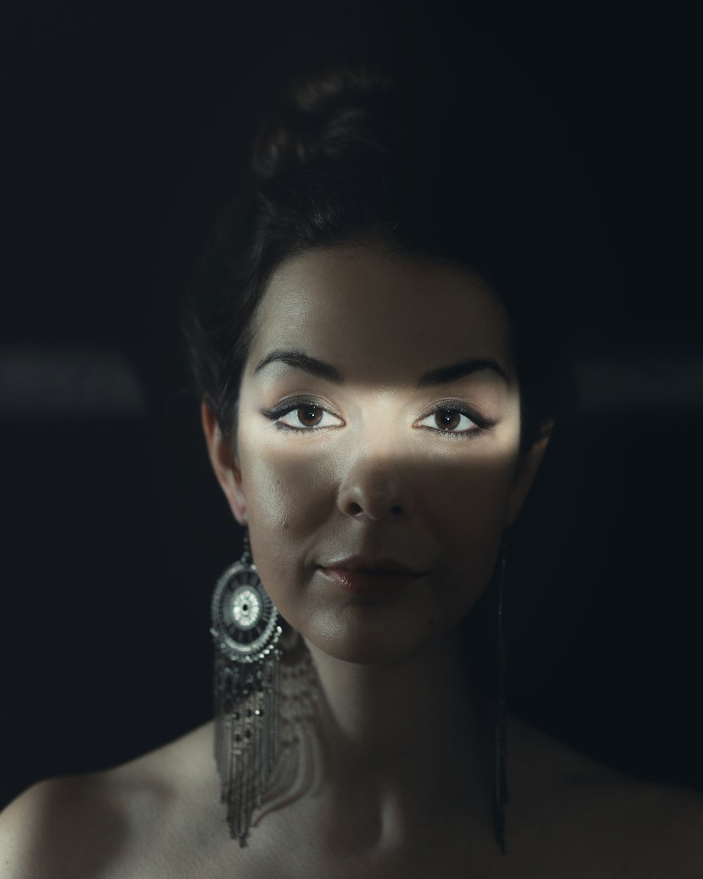 woman with silver earrings and silver earrings