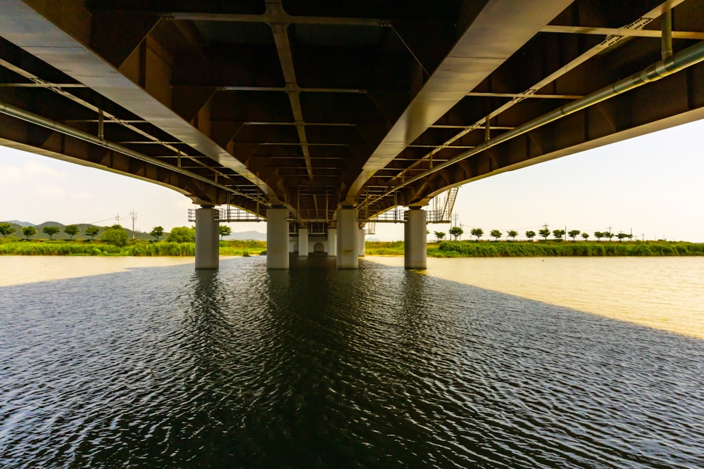 brown wooden bridge over river during daytime