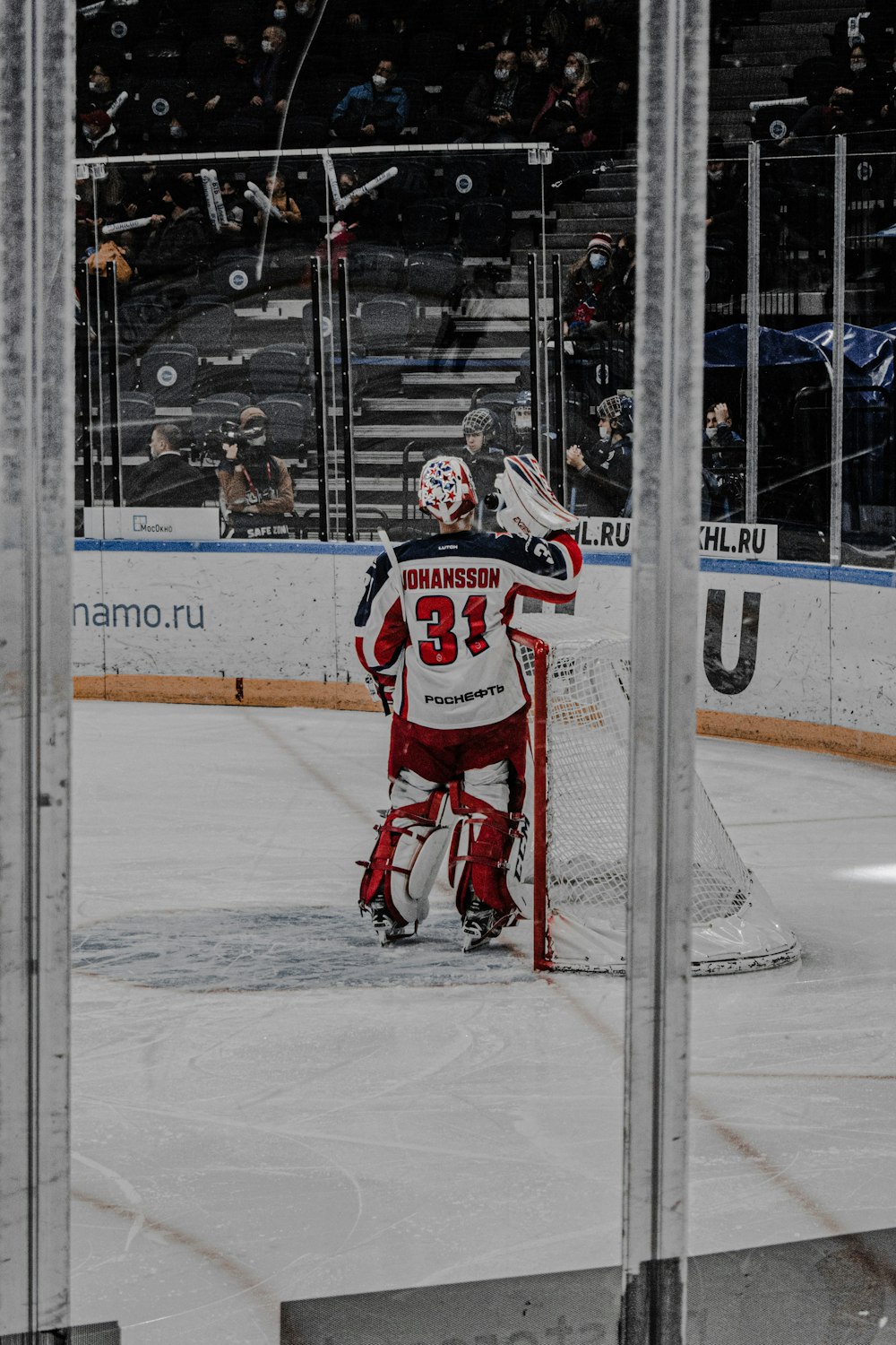 a hockey goalie standing in front of a net