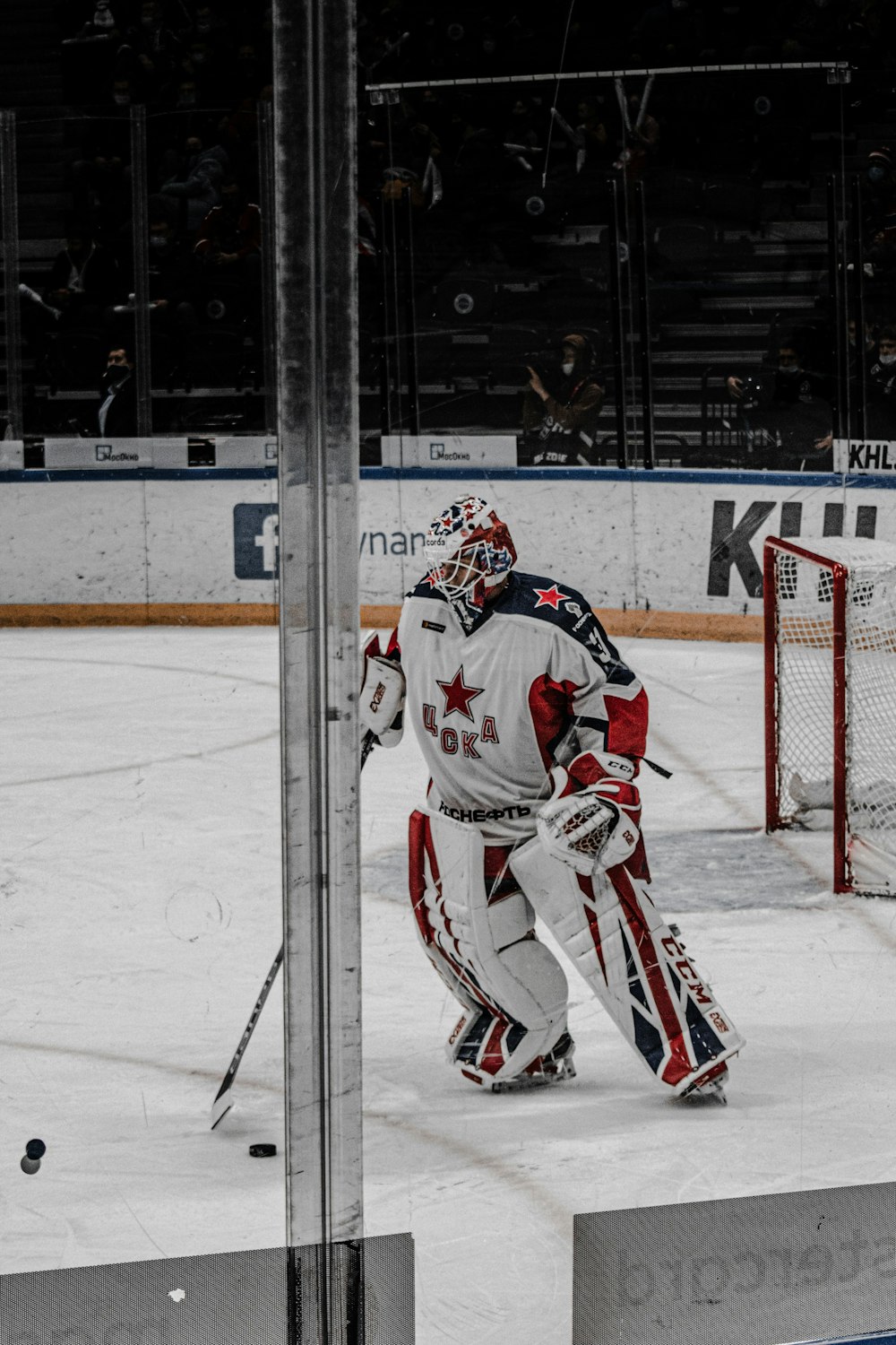 a hockey goalie standing in front of a net