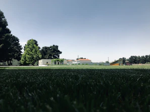 A panoramic view of the campus sports facilities under a clear blue sky.