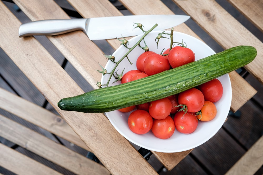 red tomato on white ceramic plate