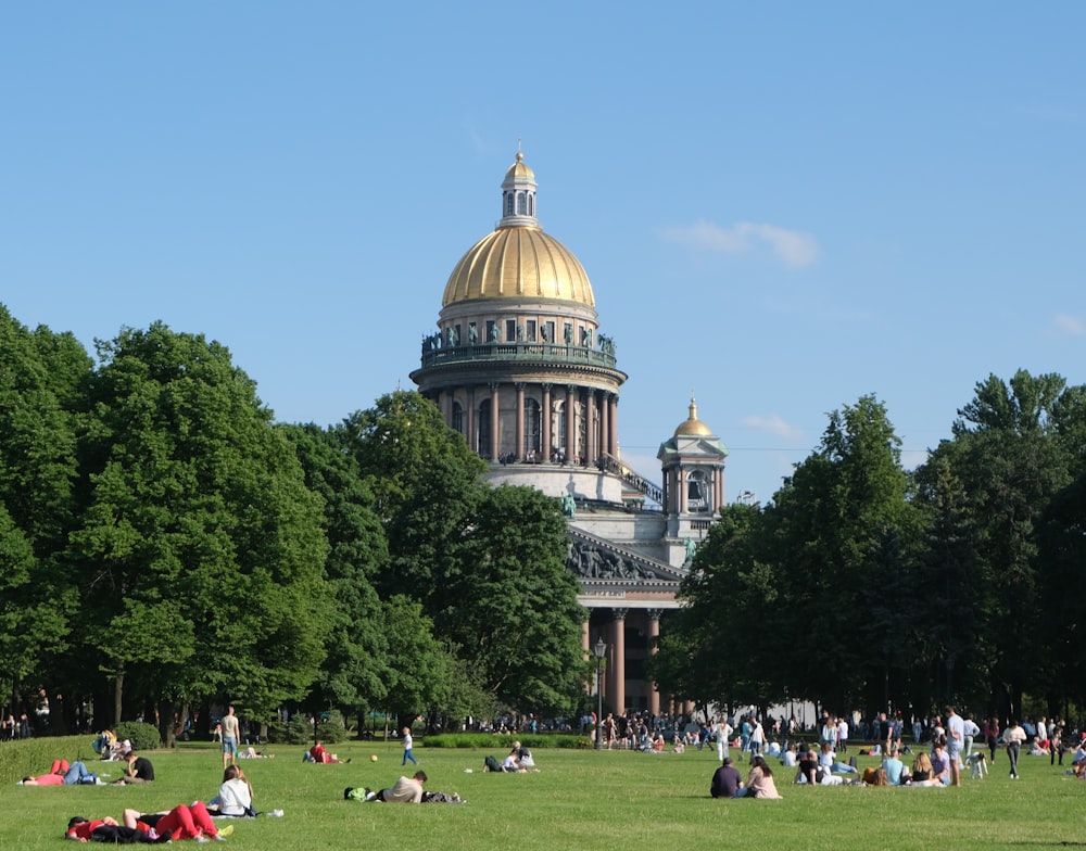 people walking on green grass field near brown dome building during daytime