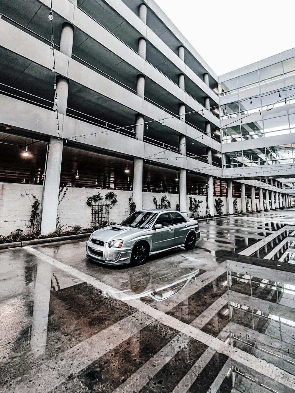 silver sedan parked on gray concrete road