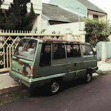 A roofer's van parked outside a home with a phone showing a missed call notification.