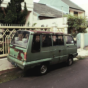 A roofer's van parked outside a home with a phone showing a missed call notification.