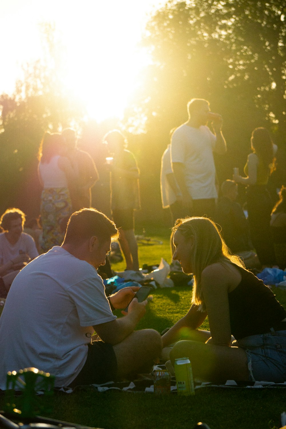 people sitting on green grass field during nighttime