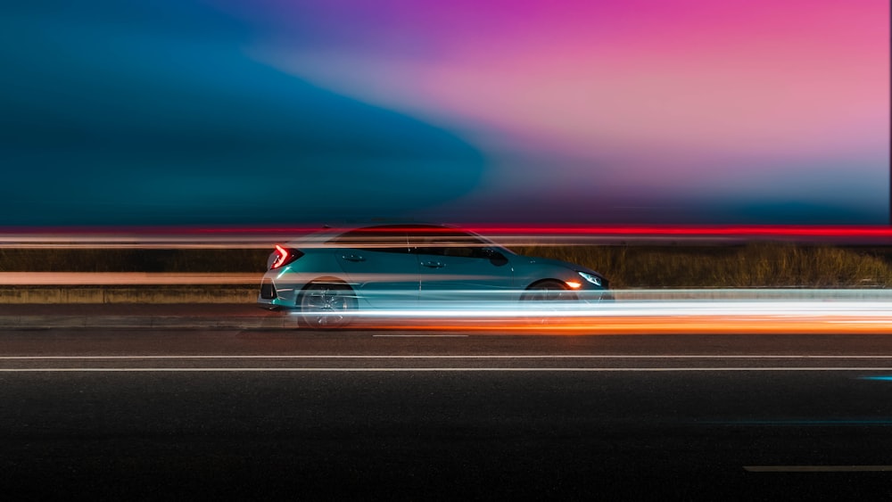 red coupe on road during night time