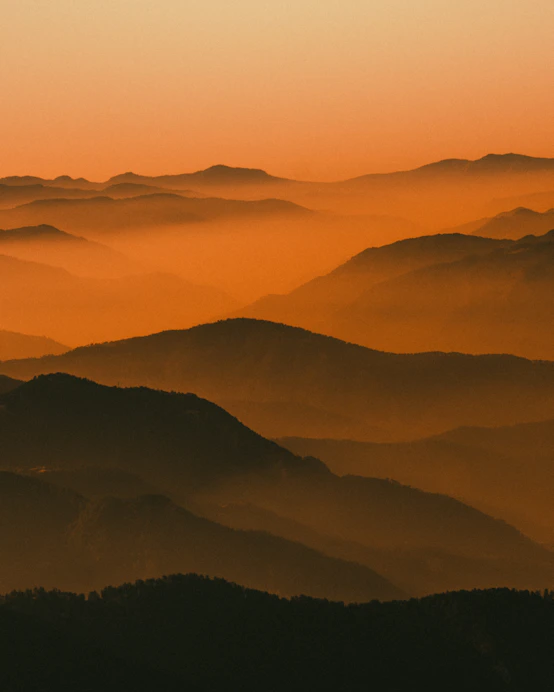 mountains covered with fog during daytime
