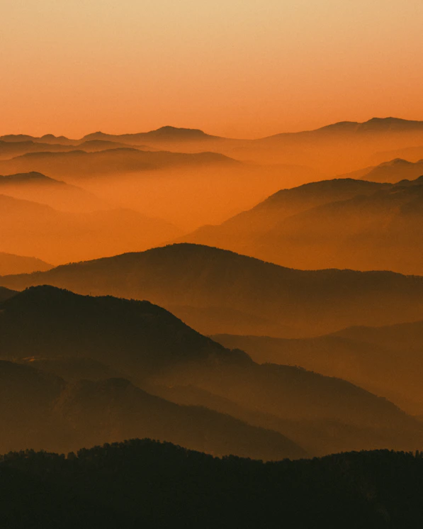 mountains covered with fog during daytime