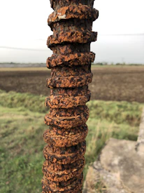 Side-by-side comparison of GFRP rebars and traditional steel rebars highlighting corrosion resistance.