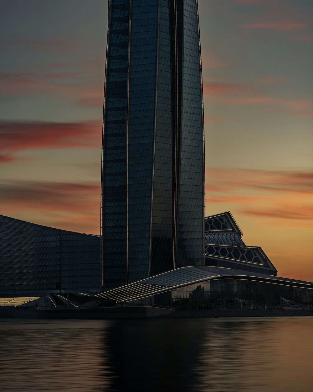 a large tall tower with a sunset in the background