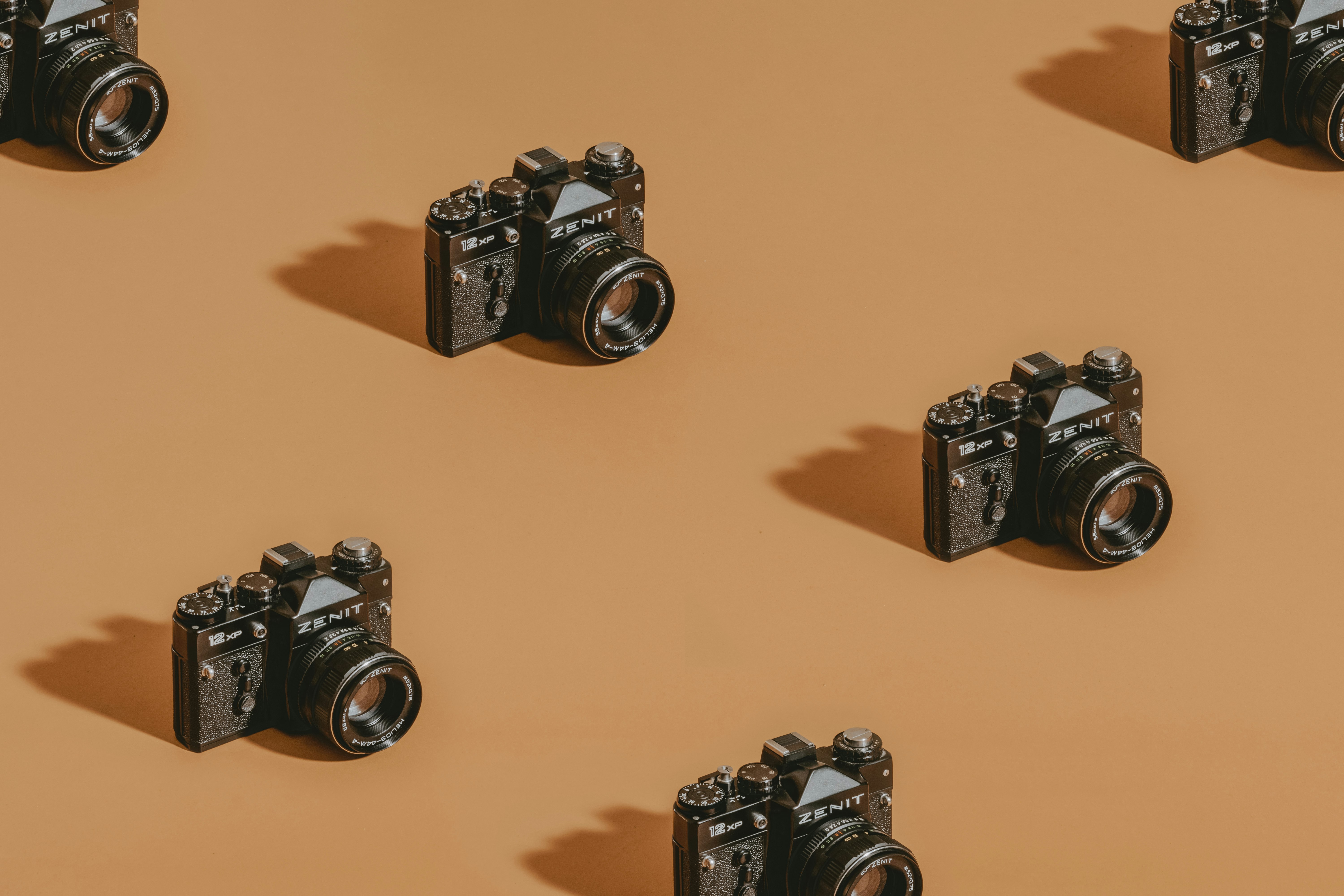 black dslr camera on brown wooden table