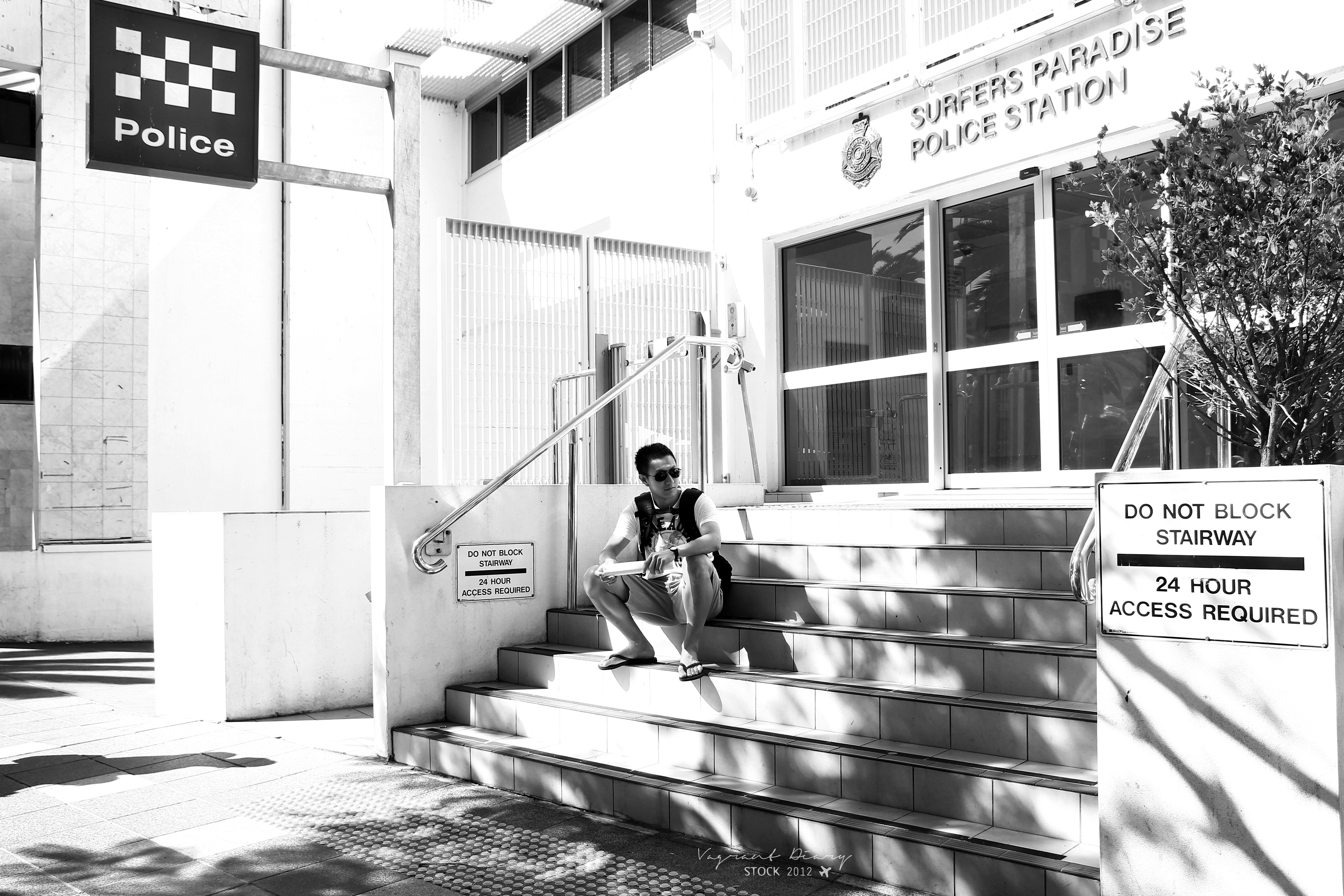 grayscale photo of woman sitting on bench