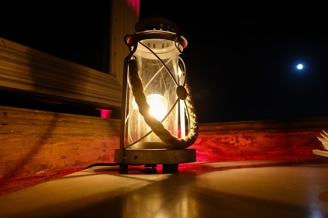 clear glass candle holder on brown wooden table