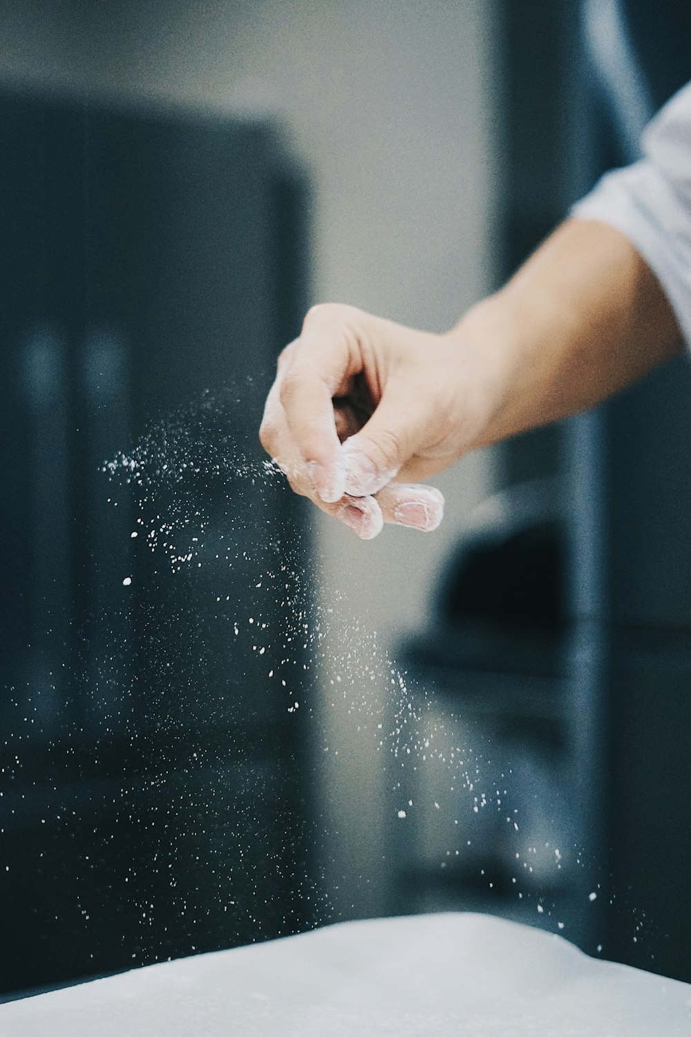 person holding water droplets on glass