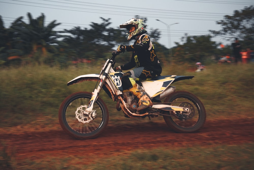 man riding on white and black motorcycle